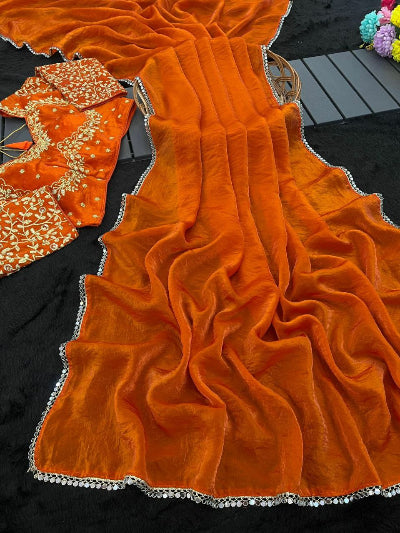 Orange saree with black blouse on a black surface
