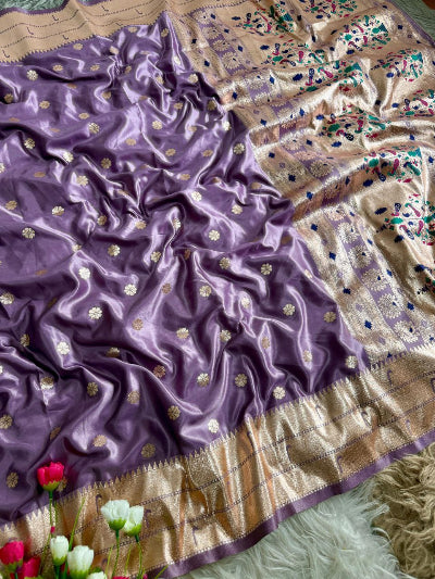 Purple and beige saree with floral patterns on a textured surface