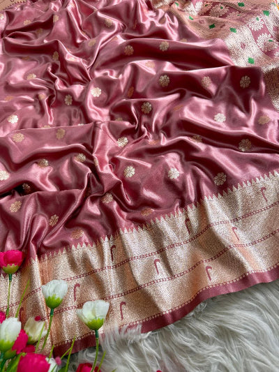 Pink saree with gold patterns on a white background