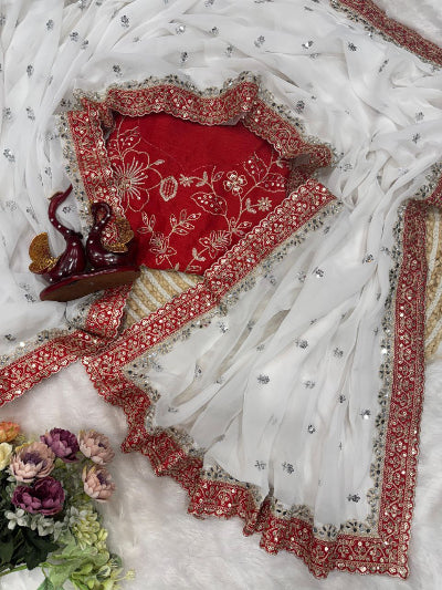 Embroidered red and white fabric with floral patterns on a white background