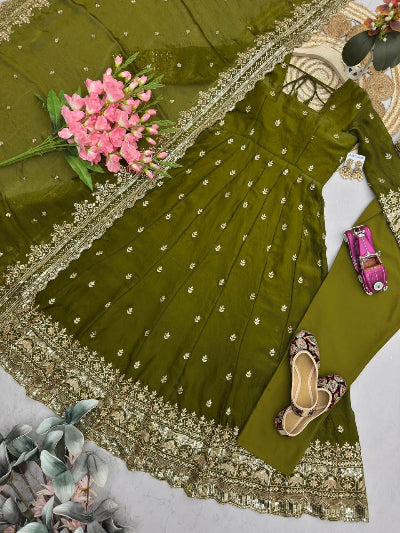 Green embroidered dress with pink flowers and a pink toy car on a white background