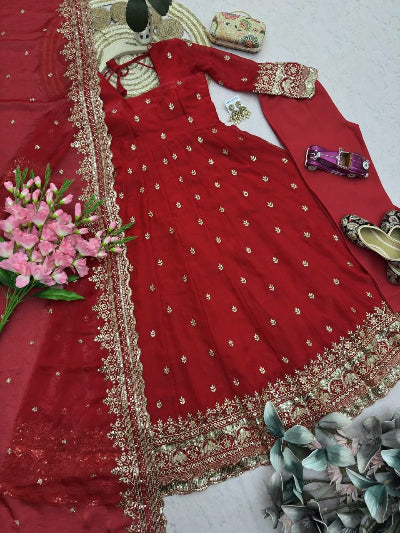 Red embroidered traditional outfit with gold details on a white background