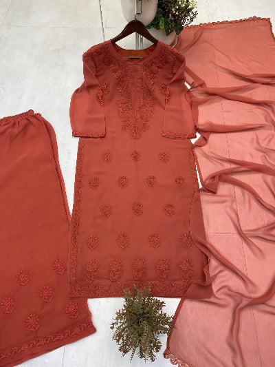 Coral pink traditional outfit with embroidery on a white background