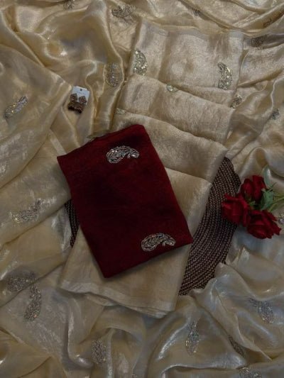 Red fabric with decorative elements on a textured beige fabric background