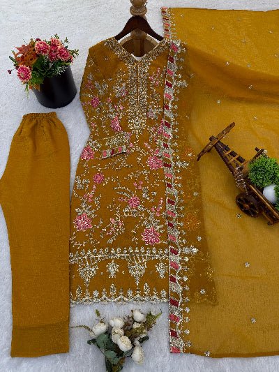 Mustard yellow embroidered outfit with pink floral patterns on a white background