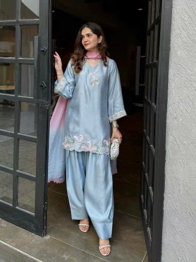 Woman in a light blue traditional outfit 