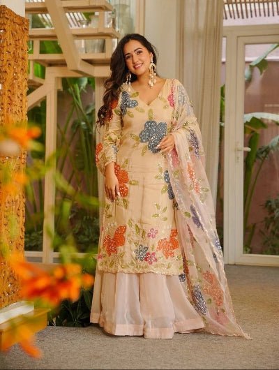 Woman in a floral traditional outfit beige modest fashion in UK muslim eid alwar suit 