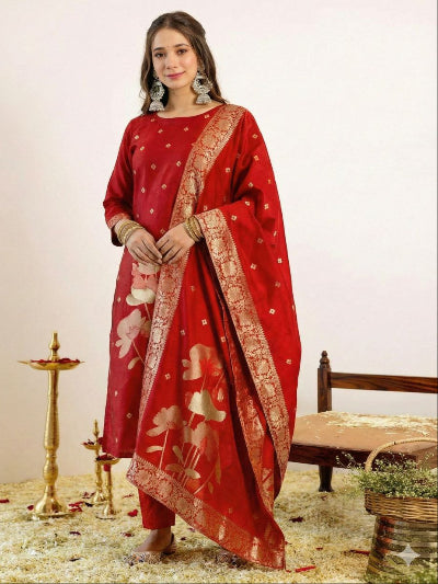 Woman wearing a red traditional outfit with floral patterns on a neutral background