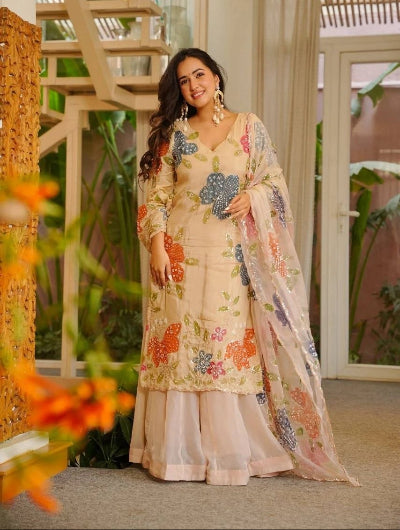 Woman in a floral traditional outfit beige modest fashion in UK muslim eid alwar suit 