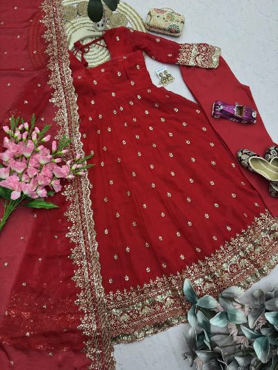 Red embroidered traditional outfit with gold details on a white background